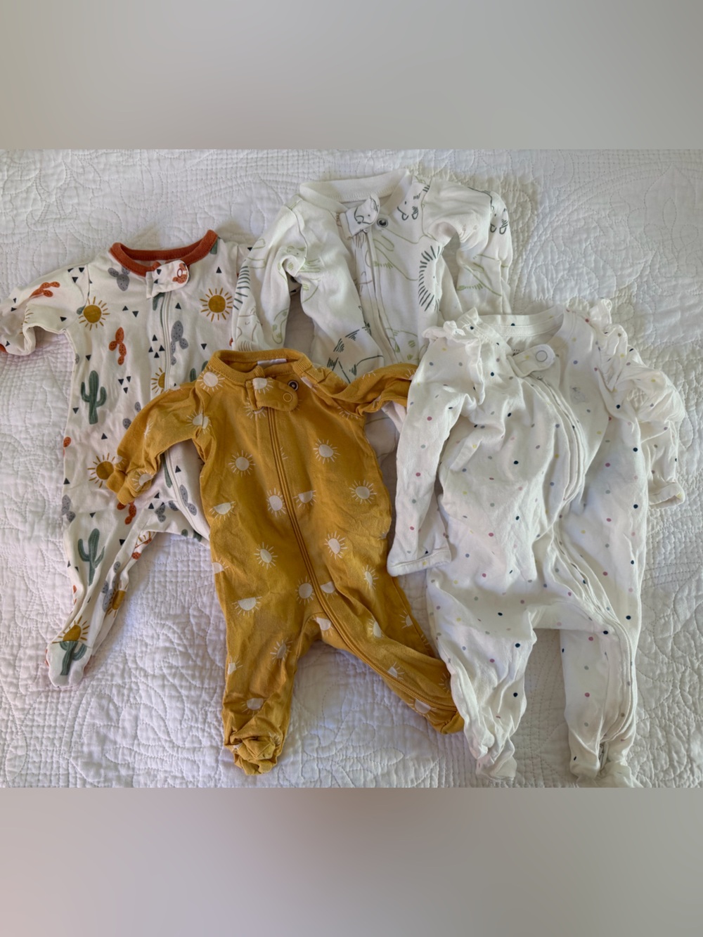 Gerber, Baby Gap and Carter’s - four assorted preemie footed onesies